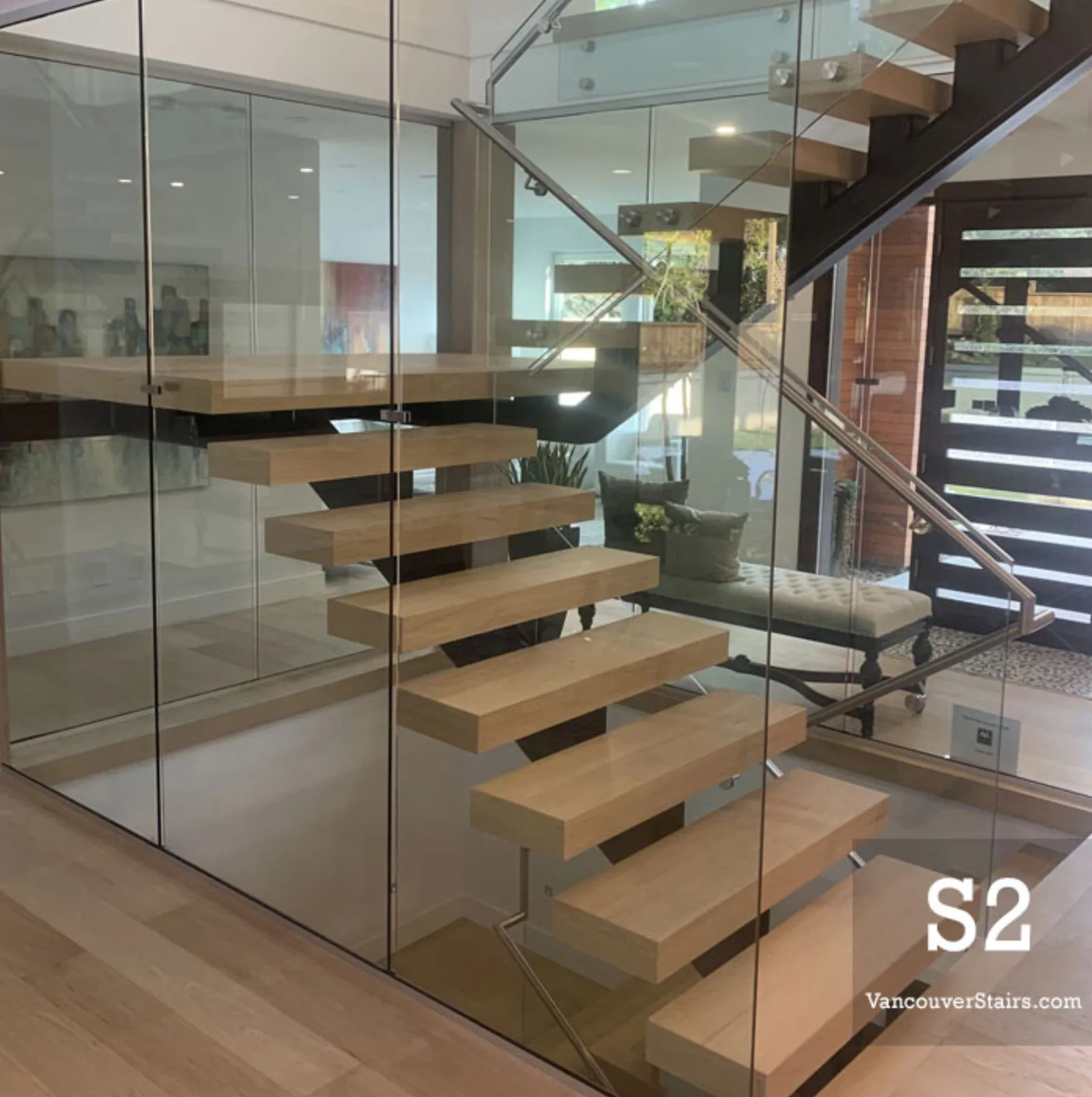 Interior mono stringer staircase with oak treads and glass enclosure